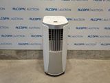 a white air conditioner sitting in front of a wall