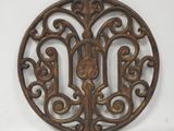 an image of a circular wooden plaque with a design on it