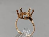 a close up of a gold ring on a clear surface