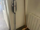 a mop that is next to a radiator in a room