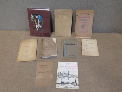 an assortment of old books are sitting on a table