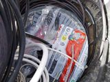 a black bucket filled with wires and other electrical equipment