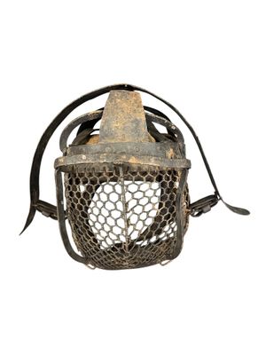 an old metal lantern with a wire mesh cover and a metal handle