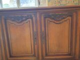 a wooden cabinet that has a door on top of it