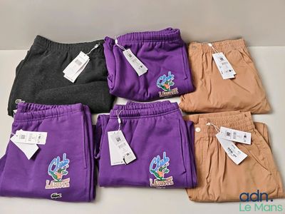 five pairs of purple, black, and brown pants with tags on them