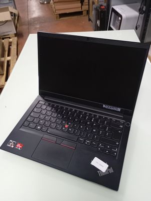 a laptop that is sitting on a table in a warehouse