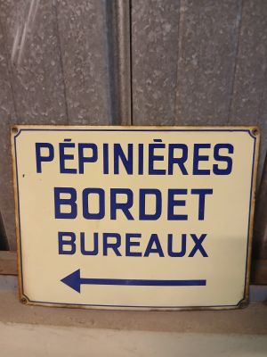 a blue and white sign on a window sill