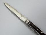 a picture of a knife that is on a table