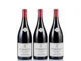 three bottles of red wine sitting next to each other on a white surface