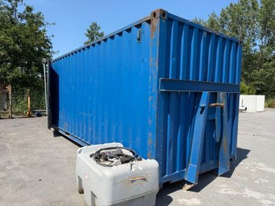 a blue container sitting in the middle of a parking lot