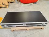 a black case sitting on top of a pallet in a warehouse