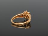 a close up of a gold ring with a flower on it