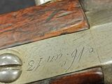 a close up of a gun with a chain on it