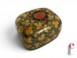 a small decorative box with a flower design on it