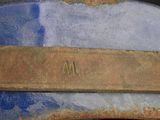 a close up of a piece of metal with a name on it