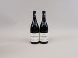 two bottles of wine sitting next to each other on a table