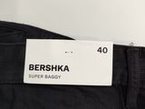 a close up of a label on the back of a pair of black jeans