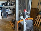 a fork lift truck that is parked in a garage