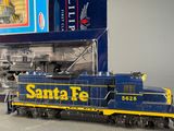 a toy train that is sitting in front of a box