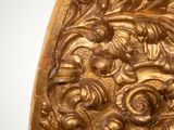an image of a gold piece of art on a white surface