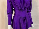 a mannequin wearing a purple top and white pants on a mannequin mannequin mannequin mannequin mannequin mannequin mann