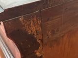a wooden table with a metal top that has rust on the top of it