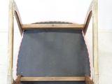 a wooden chair that has a chalk board on it