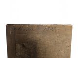 an old book with writing on it sitting on a table