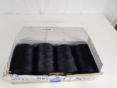 a box of black doughnuts sitting on a white table