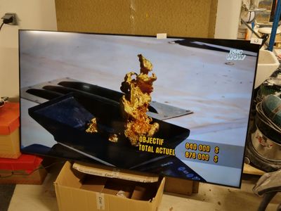 a flat screen tv sitting on top of a table