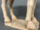 a statue of a cow with a saddle on it ' s back