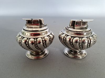 pair of silverplated salt and pepper shakers on a table