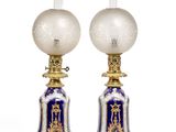 pair of blue and white lamps with gold trimmings on each of them
