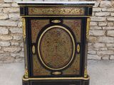 a black and gold cabinet with a marble top