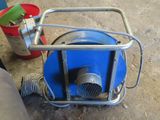 an image of a blue blower sitting on the floor