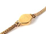 an image of a gold wrist watch with a chain around it