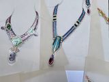 several pieces of jewelry are displayed on a white surface
