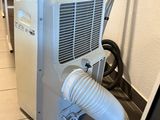 a small air conditioner sitting on the floor next to a wall