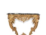 an ornately carved console table with a marble top