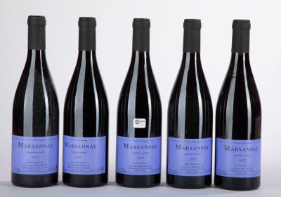 four bottles of wine are lined up on a table