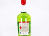 an image of a bottle of green liquid on a white surface
