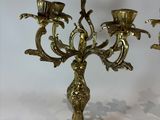 pair of antique brass candelabs with flowers on each of them