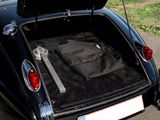 a black car with luggage in the trunk of it