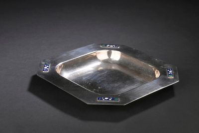 a silver plate on a black surface with blue crystals