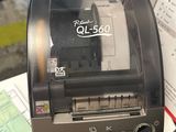 a photo of a brother ql - 240 printer sitting on a desk next to a keyboard