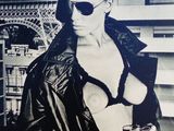 black and white photograph of a woman in front of the eiffel tower
