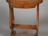 an old wooden table with a drawer on top of it