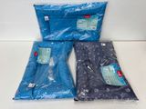 three bags of blue plastic bags sitting on top of a white counter