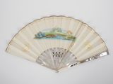 a white fan with a painting on it on a wall