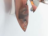 a close up of a person ' s ear with a pair of earrings on it